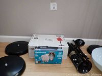 Photo showing four lamp bases on floor alongside boxed new lamp and Ecosmart LED light bulbs.