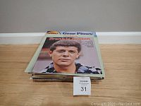 Front view of vinyl record pile with visible top two albums by Gene Pitney and Frankie Avalon.