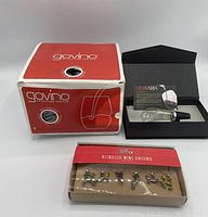 Photo shows the boxed Govino wine glasses, Vinoria wine aerator in its box, and packaged set of Reindeer wine charms.