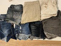 Overview photo showing seven pairs of women's shorts in assorted colors and styles, sizes 2-4.