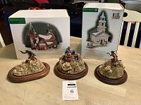 Three Civil War battle scene displays on wood bases, two without covering and one with glass globe top, plus boxes of Dept 56 New England Village Series collectible buildings.