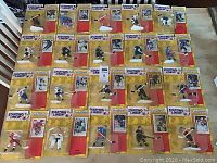 Full collection of 20 NHL Starting Lineup 1994 hockey figures displayed on table, all sealed on original cards showing various teams and players.