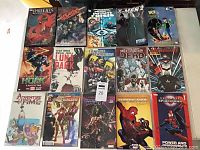 Photo showing 20 comic books and graphic novels including Spider-Man, X-Men, Ben 10, Hulk, Adventure Time and The Walking Dead.