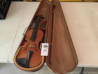 Violin and bow in open period case viewed from above