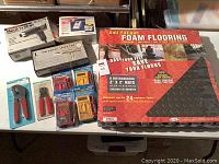 Overview of 10 items including Anti-Fatigue Foam Flooring pack, Heat n Strip paint remover, pneumatic speed saw, ICONroller mouse alternative, 4 multimeter testers, 2 crimping tools.