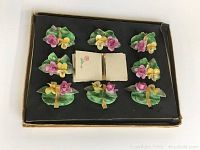 Vintage floral placecard set in black box, showing 8 placecard holders and one set of placecards.