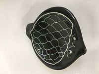 Top-down view of black ceramic fish shaped dish with white wavy line pattern and eyes on the textured dish.