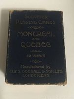 Blue box with gold embossed text reading 'Souvenir Playing Cards Montreal and Quebec 52 Views Manufactured by Chas. Goodall & Son Ltd. London, Eng.' showing edge wear and aging.