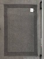 Gray rectangular rug measuring 30x46 inches with a textured pattern and solid border, laid flat on the floor and photographed from above.