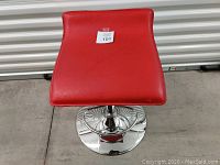 Top view showing red seat with slight curve and sticker number 101 on the seat.
