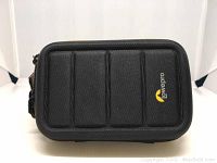 Front view of black Lowepro camera case showing shaped rigid exterior and Lowepro logo