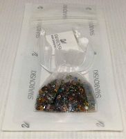 Swarovski branded organza bag with multicolored Swarovski crystals in retail packaging.