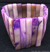 Close-up view of the soapstone bracelet showing the purple and white marbled rectangular beads in a cuff shape.