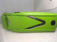 Top view of the green Borner V Power Mandolin slicer unit showing the V-shaped stainless steel blades and handle.