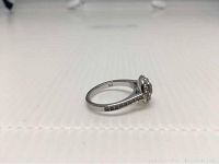 Side view of silver-tone rhodium plated Swarovski Angelic ring showing size marking '52' inside band and pave crystal detailing on the band shoulders.