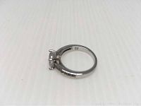 Side profile showing the rhodium plated ring band and size marking inside the band '52'.