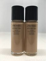 Front view of two bottles of Shiseido Synchro Skin Lasting Liquid Foundation Neutral Three with black caps and clear glass bottles showing foundation shade.