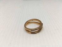 Close-up photo of the inside band of the rose gold Swarovski ring showing size 52 engraving and layered band design with crystal pavé.