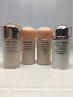 Four small Shiseido skincare emulsion bottles side by side showing front labels and caps.