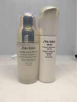 Two bottles of Shiseido moisturizers side by side: Future Solution LX with SPF 20 and Ibuki Protective Moisturizer with SPF 18.