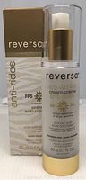 Frontal view of new Reversa anti-wrinkle cream SPF 30 bottle with pump and retail box with minor wear.