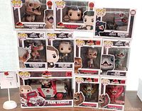 Funko Pop Jurassic Park and Jurassic World character and dinosaur figures stacked together and displayed with packaging visible.