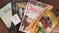 Four dinosaur books arranged side-by-side showing covers with various dinosaur illustrations and titles.