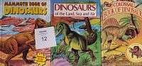 Three vintage dinosaur books displayed side by side with covers visible: Mammoth Book of Dinosaurs, Dinosaurs of the Land Sea and Air, and Colossal Book of Dinosaurs.