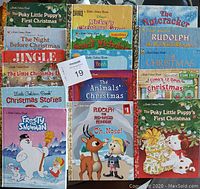 Photo of 16 Little Golden Books with Christmas themes laid out to show all front covers.