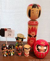 Front view of all 7 Kokeshi dolls and 1 Daruma doll, showing details and scale.