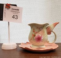 Front view of the teacup and saucer displaying Tinkerbell artwork and floral pastel design.
