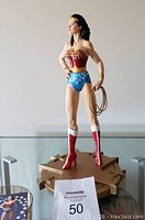 Front view of Wonder Woman Lynda Carter statue on its base with lasso and boots.