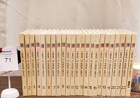 Photo of 23 vintage 'I Want To Know About' books upright, showing uniform spine design and numbering from 1 to 22 plus index book.