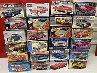 Stacked boxes of various plastic model car kits including Corvette, Plymouth Belvedere, Thunderbird, Buick GSX, Ford Galaxie, Explorer, 5-Window Coupe, Shelby Cobra GT500.