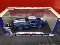 Front view of boxed model showing blue Shelby G.T. 350R with white stripes and Shelby Collectibles logo
