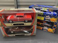 Overview of four boxed die-cast cars on a shelf