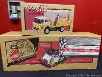 Two original Coca-Cola model boxes stacked—small 1958 C-800 box over larger tractor-trailer box