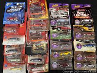 Four stacks of packaged Johnny Lightning die-cast cars on a dark surface