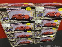 Six boxed Collectors Showcase display cases stacked on a surface