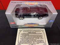 Model car in original box showing raven black 1970 Boss Mustang detailed die-cast body with clear window.
