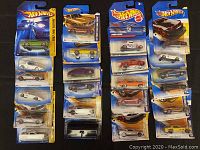 Photo showing multiple Hot Wheels cars in packaging arranged in rows featuring various models and series.