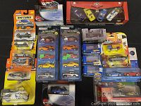Overview photo of various packed die-cast cars including Matchbox, Hot Wheels, and assorted boxed sets