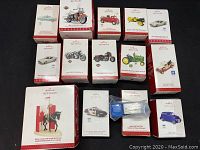 Overview of the boxed Hallmark Keepsake Christmas ornaments, showing a variety of classic vehicles and the Royal Canadian Mounted Police figurine on horse.