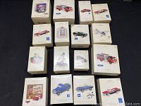 Group photo of 15 Hallmark Keepsake Christmas ornaments in original boxes featuring detailed miniature collectible vehicles and holiday figurines