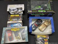 Complete lot overview featuring all included die cast cars in their boxes and packaging, showing condition and variety