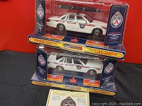 Front view of two limited edition police car models stacked in packaging showing Metro Toronto Police decals and details