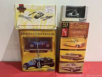 Front view showing the four different boxed items: Matchbox Models of Yesteryear Stutz Bearcat, Rollbox Collectibles box, Vespa 98 scooter model in display box, and AMT '59 El Camino customizing kit box.