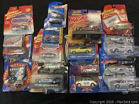 Top view showing complete lot of die cast cars in original packaging, including Johnny Lightning and Hot Wheels.