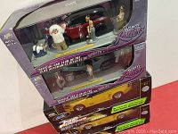 Three boxed die cast model sets stacked