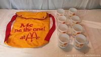 Yellow McDonald's backpack with red straps and flap closure printed with 'Me I'm the one! at McDonald's' and a maple leaf symbol.